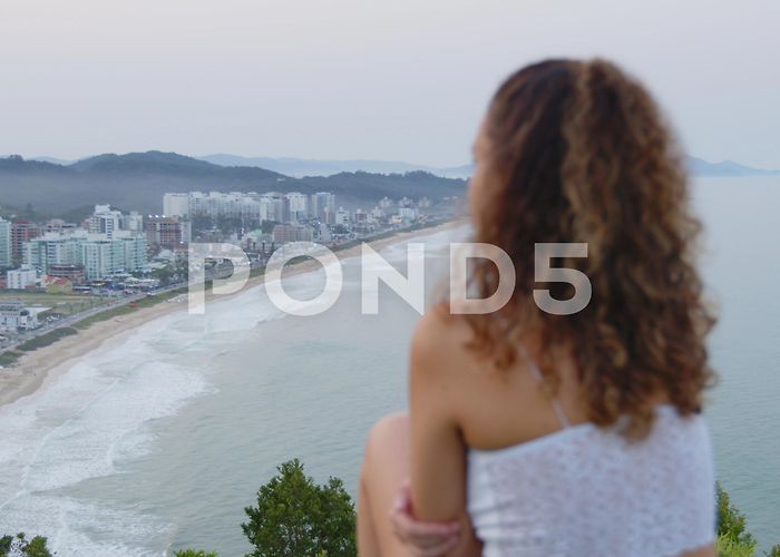 Careca Hill Cute girl admiring the sunset at careca ... | Stock Video | Pond5 photo